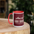 Muslim By Nature™ LEGACIES: MEN №01 Abu Bakr (RA) 15oz mug – maroon wrap with Kufic Arabic name and ABU BAKR in cream – handle on left