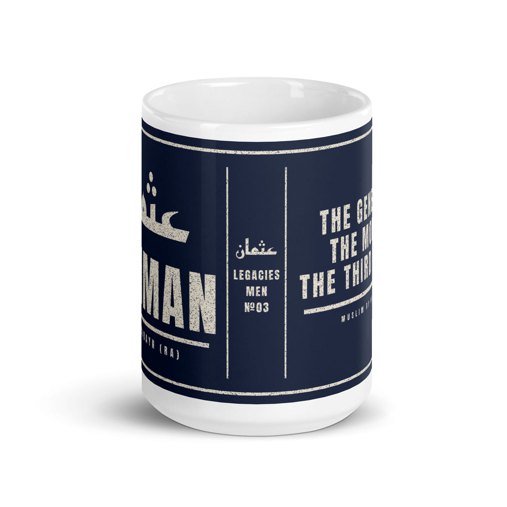 Muslim By Nature™ LEGACIES: MEN №03 Uthman (RA) 15oz white mug – navy wrap with Kufic Arabic name and UTHMAN in cream – front view