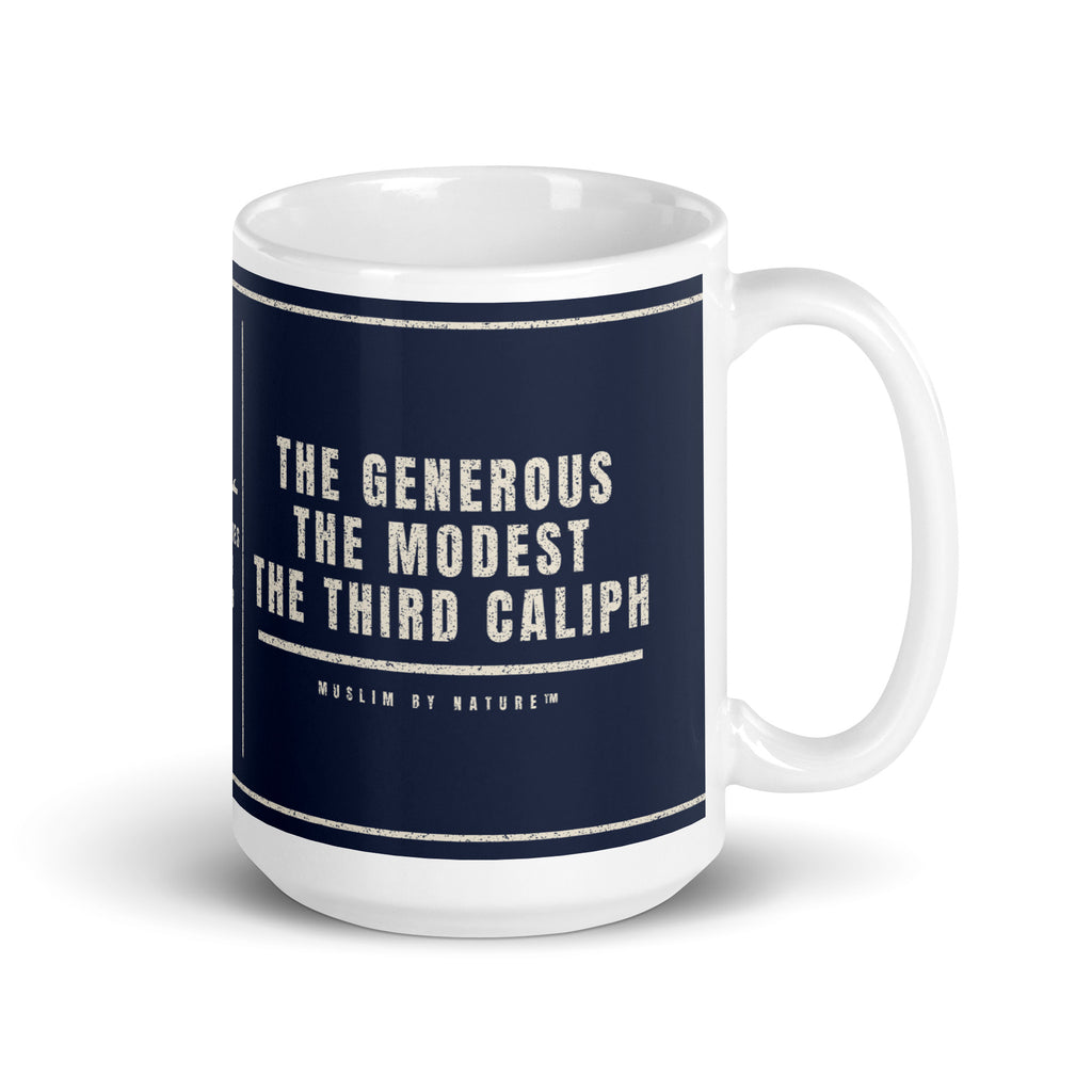 Muslim By Nature™ LEGACIES: MEN №03 Uthman (RA) 15oz white mug – navy wrap with Kufic Arabic name and UTHMAN in cream – handle on right